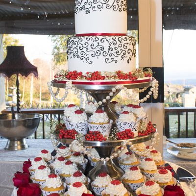 A traditional wedding cake with cupcakes for fun